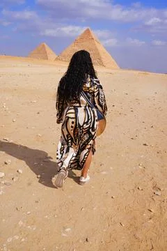 Tourist walking towards the Great Pyramids Stock Photos