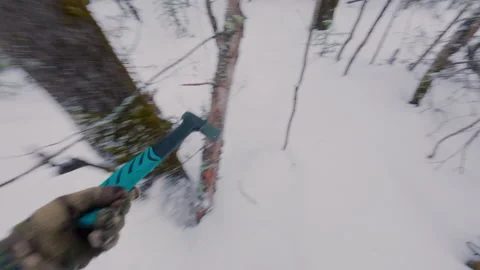 A tourist walks through a snowy forest and is looking for a courtyard. Stock Footage 322763053