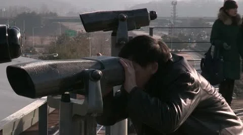 Tourist watching the border between North and South Korea Stock Footage 10574550