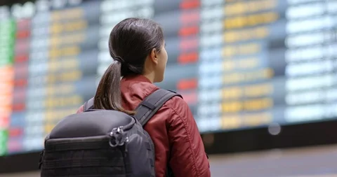 Tourist woman check the flight number in the airport Stock Footage