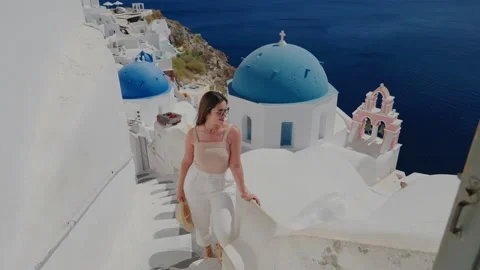 Tourist woman enjoying view at the village of Oia, Santorini Stock Footage