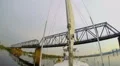 Tourist yacht sailing under river railway bridge, moving train HD Footage
