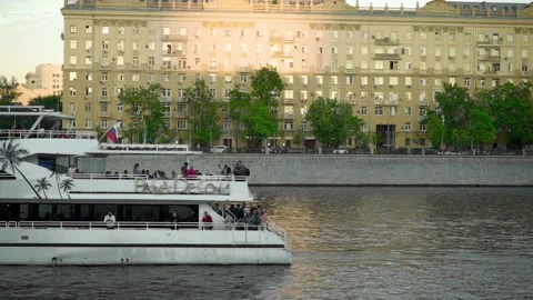 Tourist yacht sails on the river through the city Stock Footage