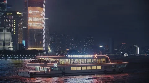 Touristic baot on the river in Shanghai by night Stock Footage 99369698