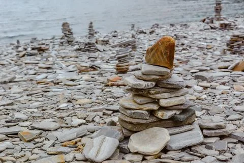 Touristic pyramid balanced stack of stones at the beach Foto stock