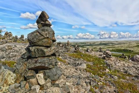 Touristic pyramid balanced stack of stones at the tundra Stock Photos