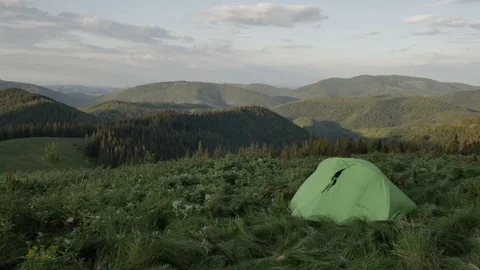 Touristic tent in mountains on sunset , wind shakes the grass Vídeos de archivo 77619143