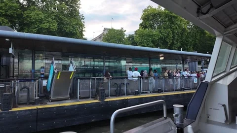 Tourists aboard a boat navigating on the River Thames as it approaches the Stock Footage 342186178