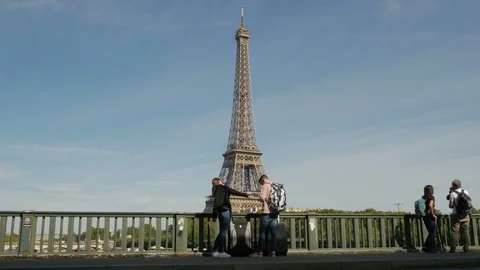 Tourists admiring the Eiffel Tower walking over the Pont de Bir-Hakeim Bridge Stock Footage 97484686