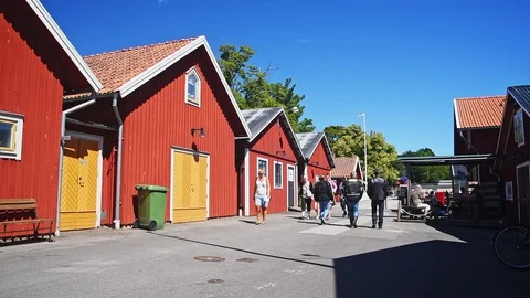 Tourists among sheds Stock Footage 95774341