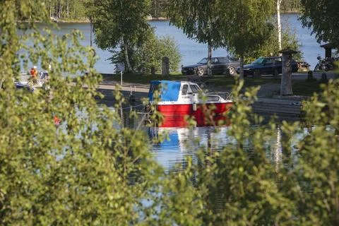 Tourists and boat at Kivisalmi rest stop/marina at lake Etelä-Konnevesi,Finland Stock Photos