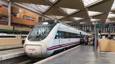 Tourists and a high speed train in the station of Zaragoza-Delicias, Spain. Stock Footage 128897928