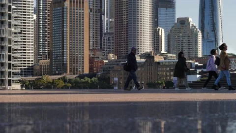 Tourists and seagulls pass Circular Quay Sydney cityscape slow motion 4K Stock Footage 201642998