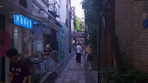 Tourists and shoppers walking down a narrow street,4k Video stock 281855027