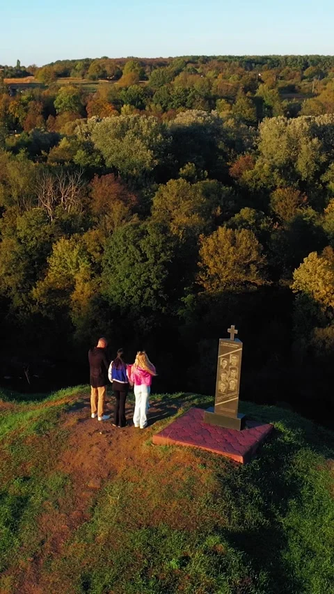 Tourists approach the edge of the mountain on which the cross stands. Vertical Stock Footage 288318528