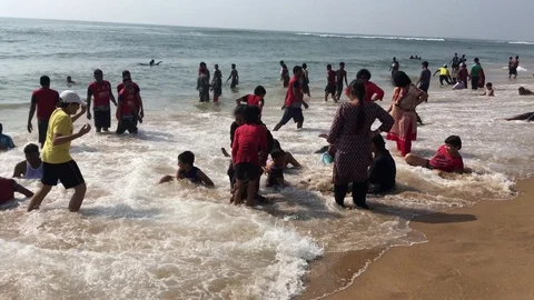 Tourists are enjoy bathing in the sea in Puri,Orissa,India Stock Footage 124190882