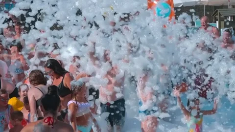 Tourists are having a great time dancing to cheerful music in the foam Video stock 323837814