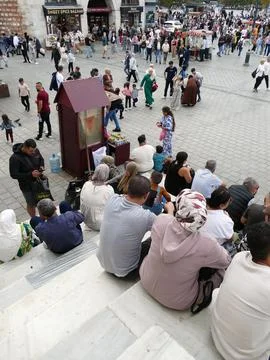 Tourists are taking a break on the steps, observing the vibrant atmosphere .. Stock Photos