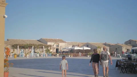 Tourists are walking through the square of Marzamemi Stock Footage 179386853