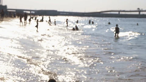 Tourists on the beach in blurred focus Stock Footage 100814149