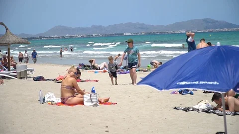 Tourists at the beach in slow motion Stock Footage 128350210