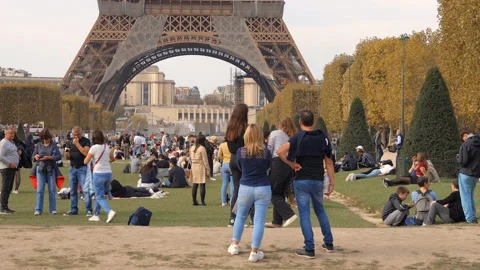Tourists being photographed in front of the Eiffel Tower in Paris, France Stock Footage 223500478