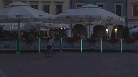 Tourists Bicycle through the Central Square of Zamosc, Poland Stock Footage 73483255