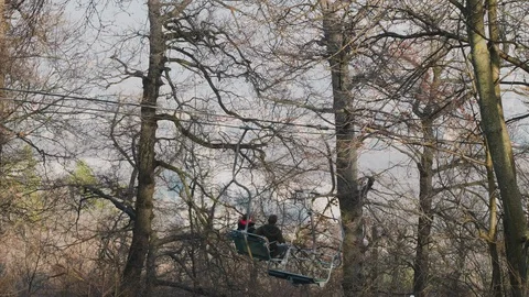 Tourists on cable car in winter forest with bare trees Stock Footage 128299963