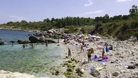 Tourists at cala mazzo di sciacca beach, riserva dello zingaro Stock Footage 280876813