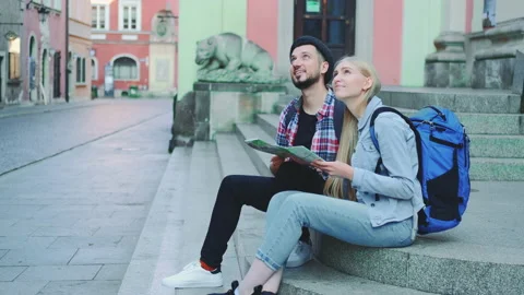 Tourists checking city map and discussing Stock Footage 142799420