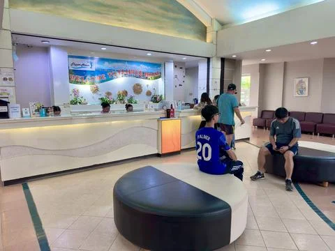 Tourists checking in at the front desk of Flipper House hotel in Pattaya city Stock Photos