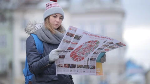 Tourists choose the direction on the map Stock Footage 57525477