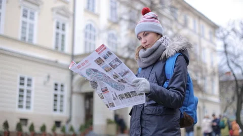 Tourists choose the direction on the map Stock Footage 57525481