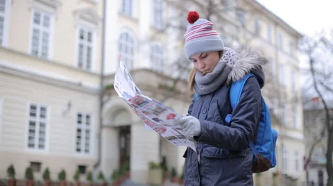 Tourists choose the direction on the map Stock Footage 57525508