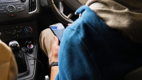 Tourists choose the direction on the map in the phone. The man is looking for a Stock Footage 101201345