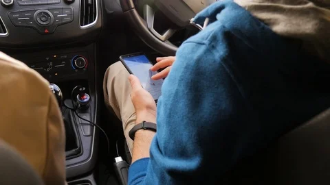 Tourists choose the direction on the map in the phone. The man is looking for a Stock Footage 101201428