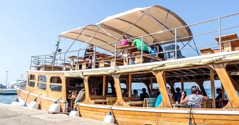 Tourists climb aboard the boat Stock Footage