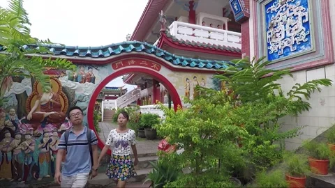 Tourists Come Through Circular Moon Gate, Kek Lok Si Temple, Penang, Malaysia Stock Footage 296370475