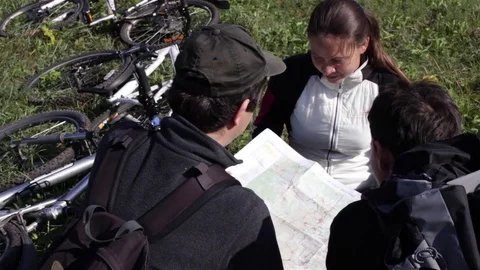 Tourists on cycling trip looking on map Stock Footage 74774344