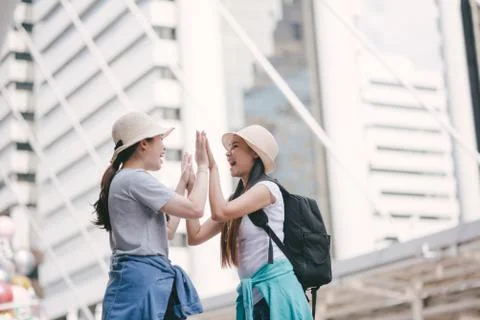 Tourists Doing High Five While Standing In City Stock Photos