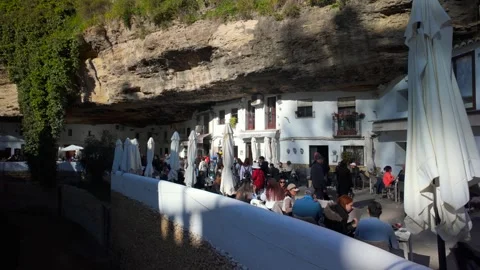 Tourists eating outside seating in Setenil De Las Bodegas, Andalusia, Spain - 4K Stock Footage 337322003