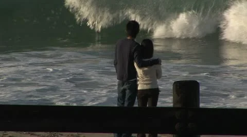 Tourists embracing watching waves Stock Footage 11641801