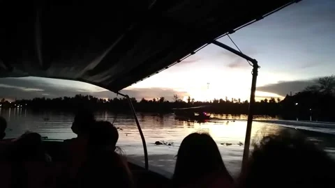 Tourists is enjoying at sunset by taking a long-tail boat Stock Footage 341104890
