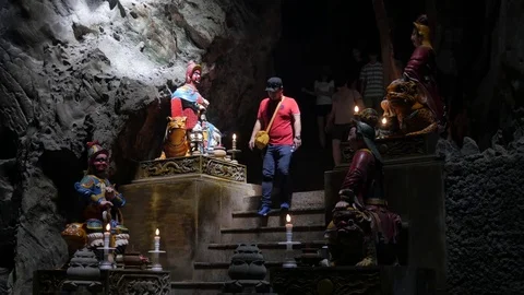 Tourists enter cave with buddhist statues at Marble Mountains,DaNang,Vietnam Stock Footage