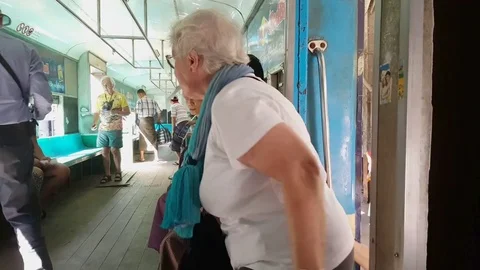 Tourists enter Yangon circular train wagon, Burmese locals, wagon interior Stockbeeldmateriaal 78076702