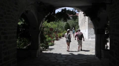 Tourists entering monastery through an arc Stock Footage 40353126