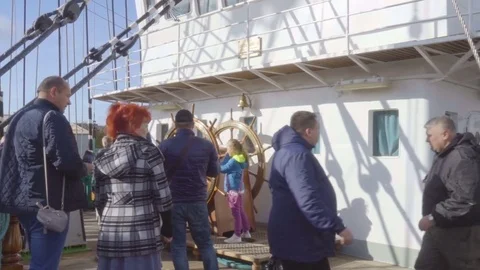Tourists on excursions walk along the deck of the ship sailboat Kruzenstern. Stock Footage
