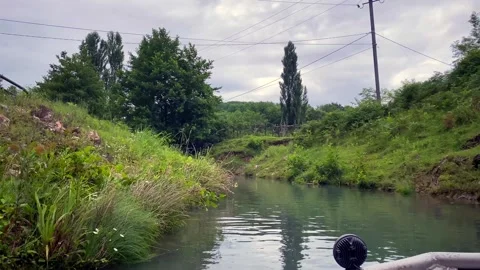 Tourists exiting Prometheus Cave by boat enter an outdoor canal in Georgia Stock Footage 340386945