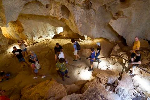 Tourists Explore The Bat Ecosystem At Capricorn Caves Australia Stock Photos