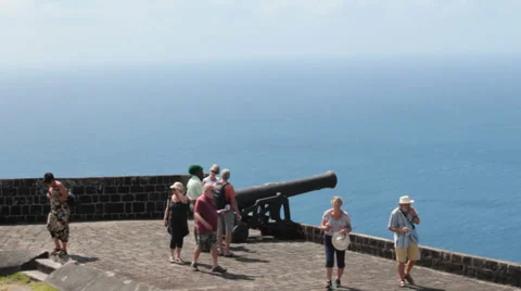 Tourists explore cannon on old fort on caribbean island Stock Footage 36778947